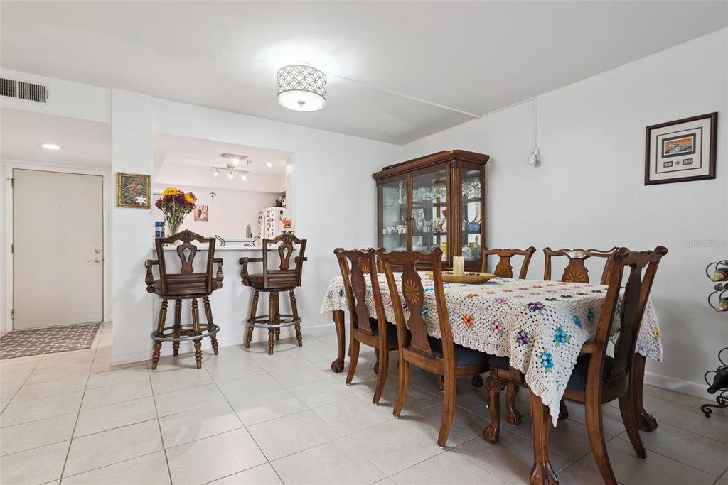A dining room features a wooden table with chairs, a hutch, and a breakfast bar — 530 CRANES WAY UNIT 107, ALTAMONTE SPRINGS, FL
