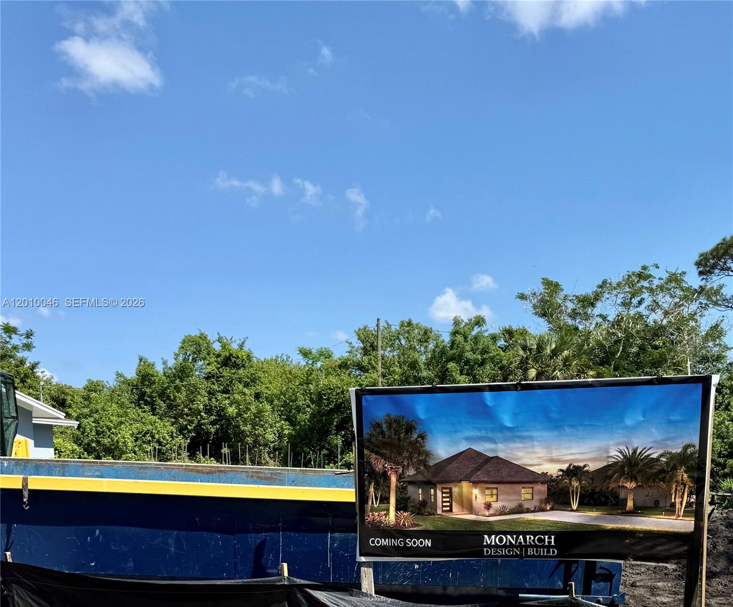 A construction site features a rendering of a future house on a large sign — 2104 Barcelona Ave, Fort Pierce FL 34946, FORT PIERCE, FL