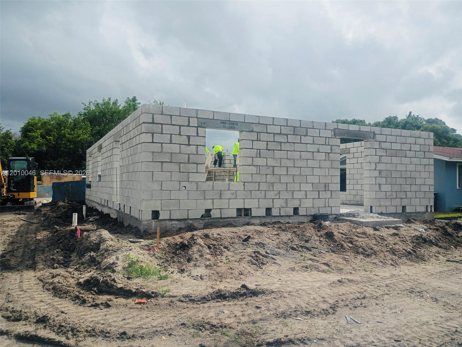 A construction site shows a concrete block wall structure with workers visible through a window opening — 2104 Barcelona Ave, Fort Pierce FL 34946, FORT PIERCE, FL