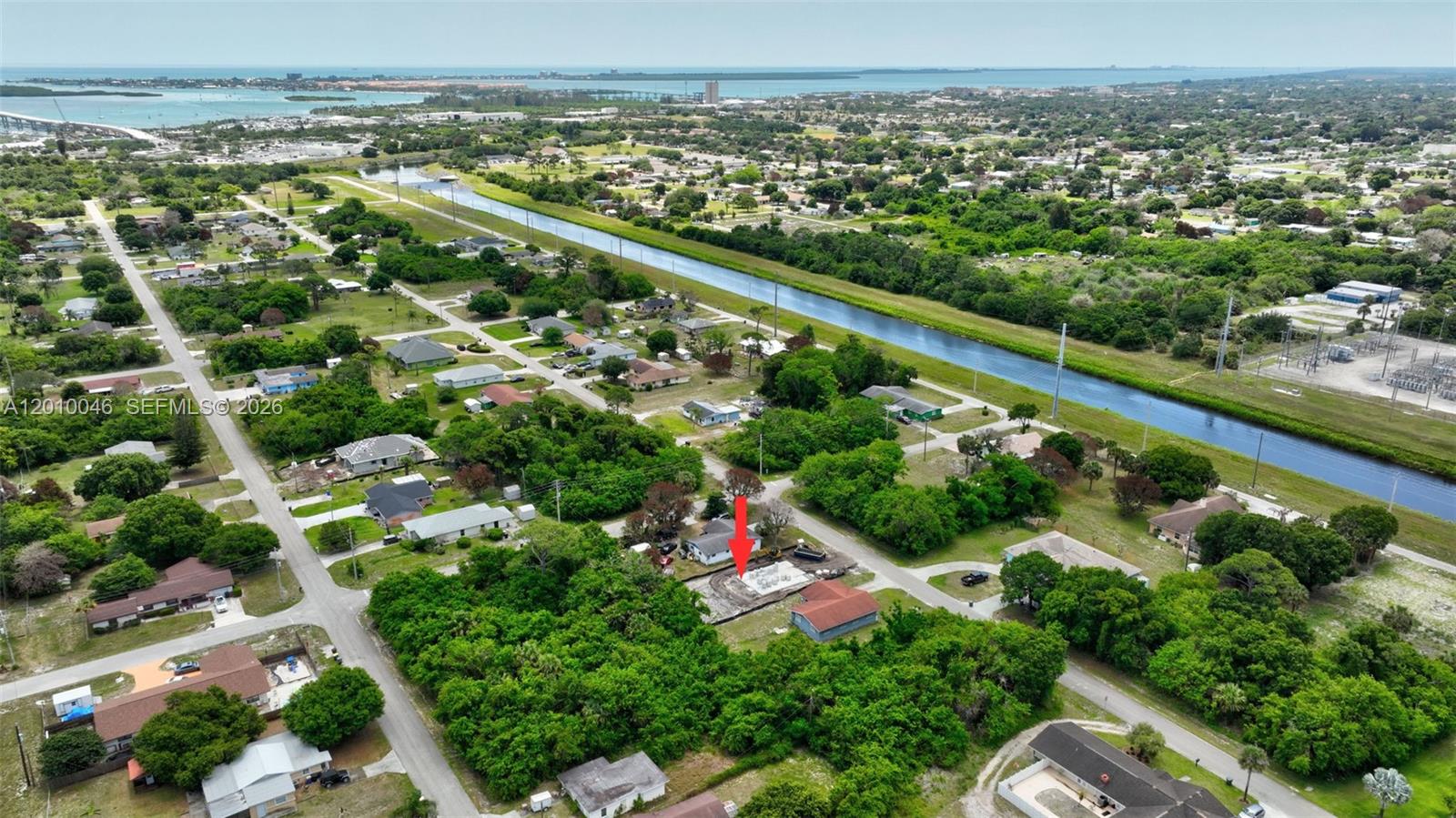 An aerial view shows a residential neighborhood with a red arrow pointing to a construction site — 2104 Barcelona Ave, Fort Pierce FL 34946, FORT PIERCE, FL