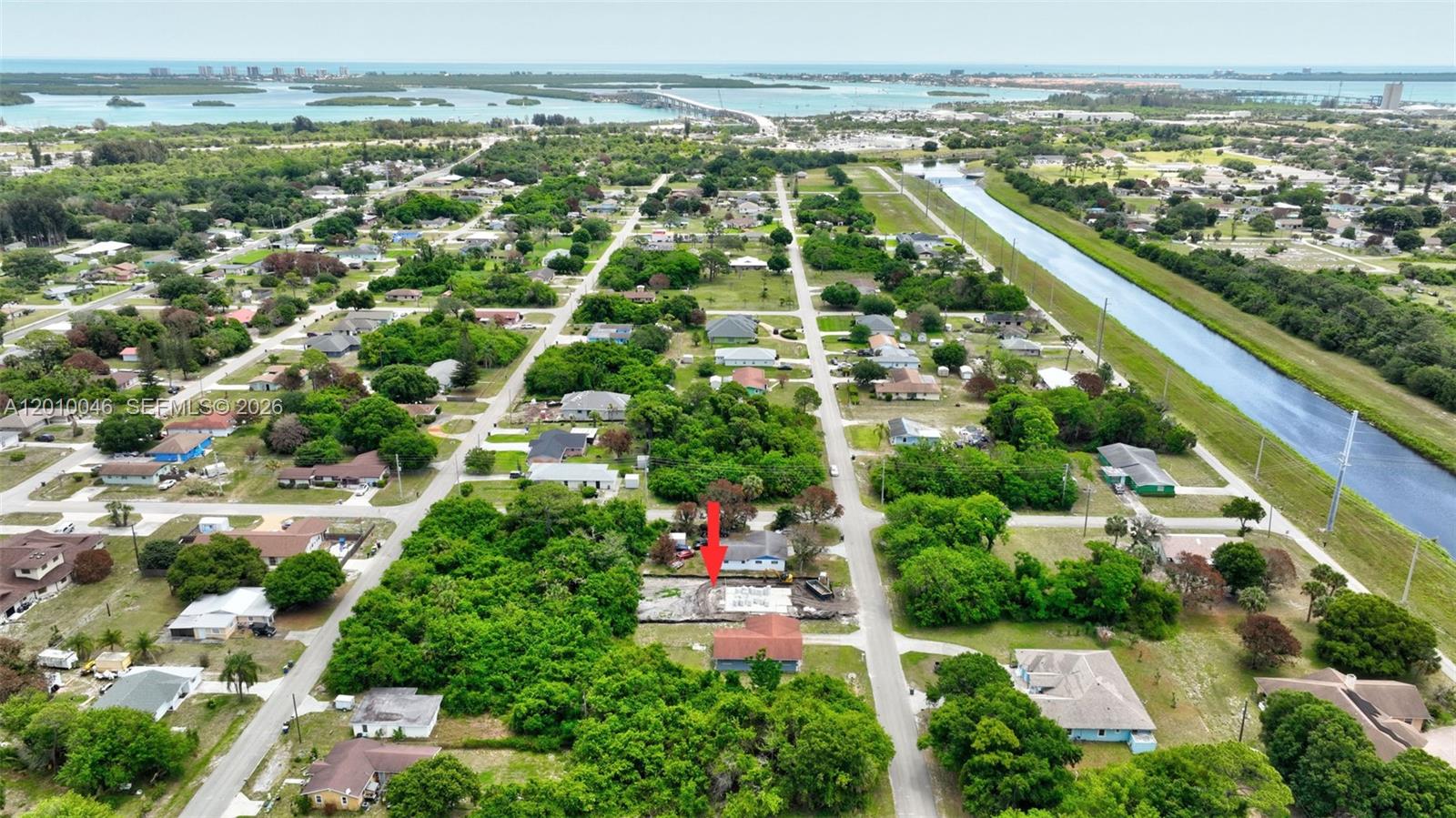 An aerial view shows a residential neighborhood with a red arrow pointing to a construction site — 2104 Barcelona Ave, Fort Pierce FL 34946, FORT PIERCE, FL