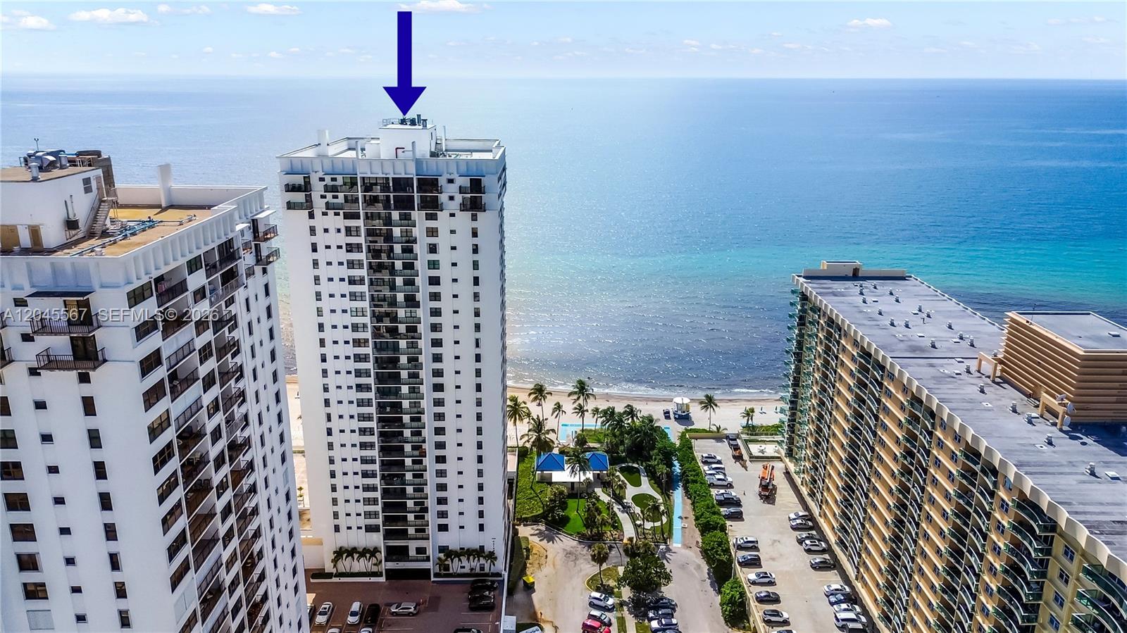 An aerial view shows three high-rise residential buildings situated along a sandy beach — 2301 S Ocean Dr # 1006, Hollywood FL 33019, HOLLYWOOD, FL