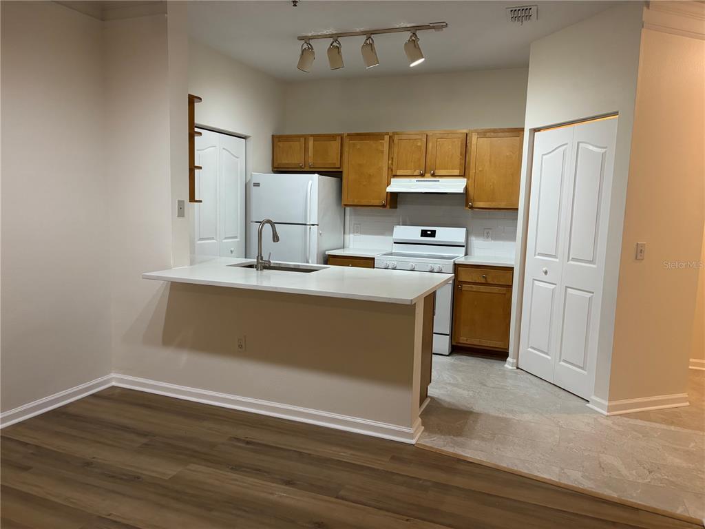 An entryway with light-colored tile flooring, a white front door, and a louvered closet door — 4207 S DALE MABRY HIGHWAY UNIT 11108, TAMPA, FL