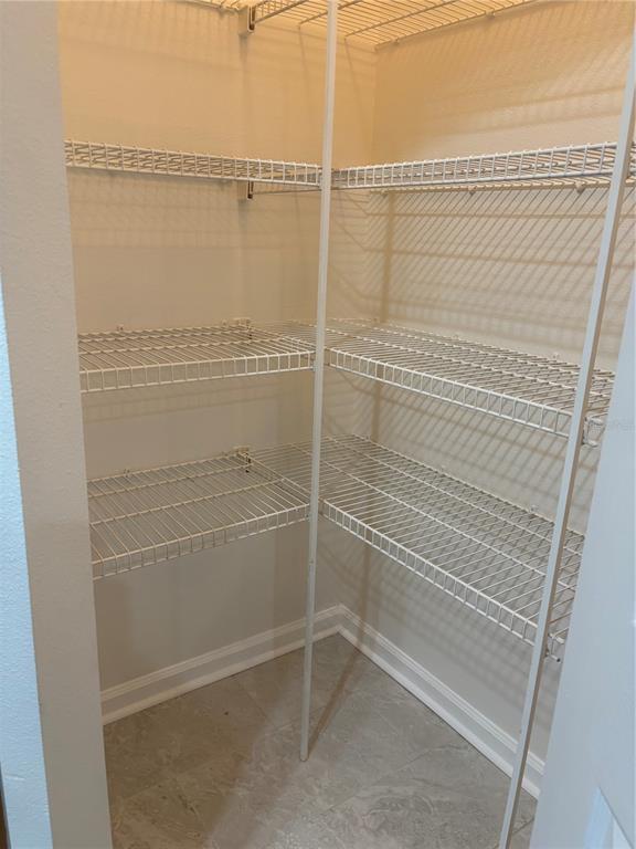 A kitchen features white countertops, wooden cabinets, a white refrigerator, and a white electric range — 4207 S DALE MABRY HIGHWAY UNIT 11108, TAMPA, FL