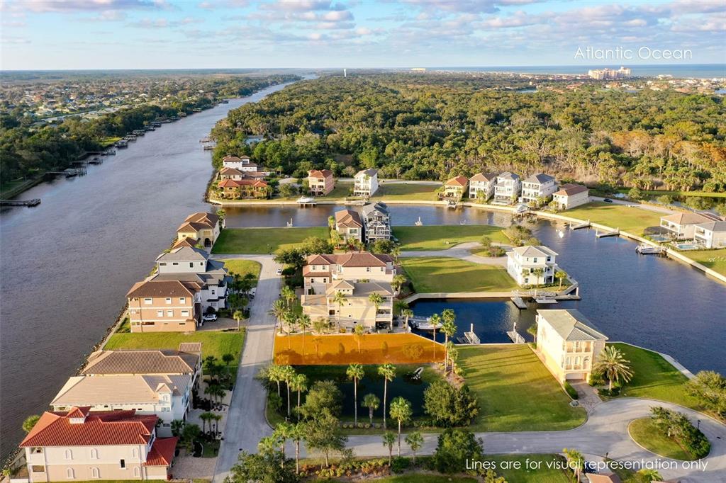 An aerial view shows a vacant waterfront lot highlighted in orange within a residential community — 297 YACHT HARBOR DRIVE, PALM COAST, FL