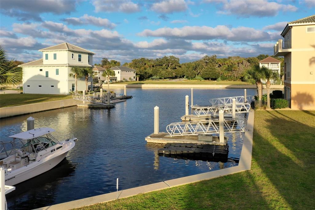 A view of a canal with boat docks and houses under a cloudy sky — 297 YACHT HARBOR DRIVE, PALM COAST, FL