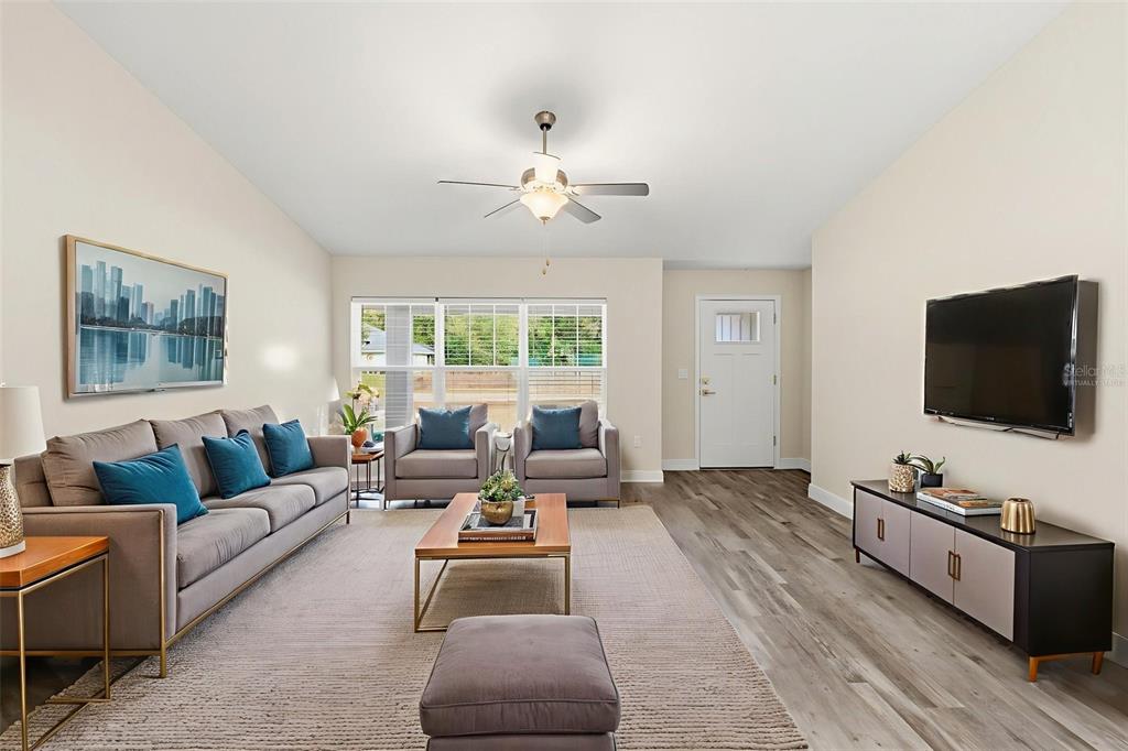 A living room features gray furniture, a wooden coffee table, and wood-look flooring — 9960 N SHERMAN DRIVE, CITRUS SPRINGS, FL