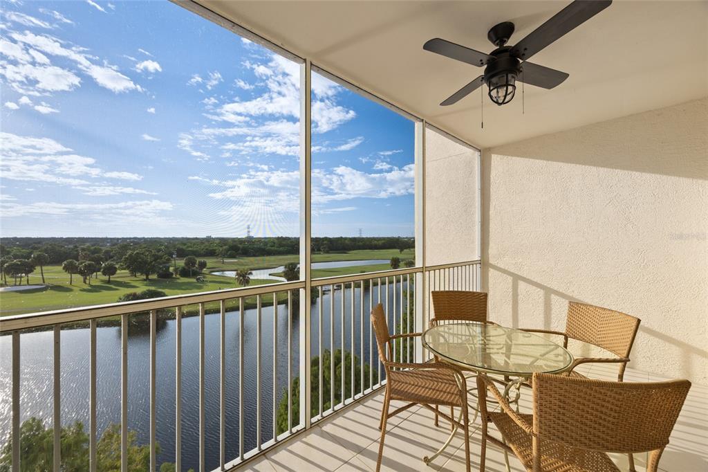 A screened balcony with a ceiling fan, wicker furniture, and a view of a golf course — 1200 COUNTRY CLUB DRIVE UNIT 5402, LARGO, FL