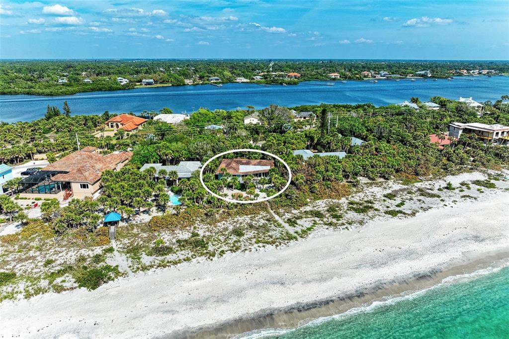 An aerial view shows a beach house circled in white near the ocean shoreline — 8320 MANASOTA KEY ROAD, ENGLEWOOD, FL