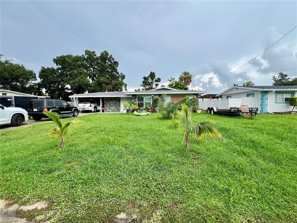A single-story house with a stone facade and a large front yard with two palms — 3246 EAGLE STREET, SARASOTA, FL
