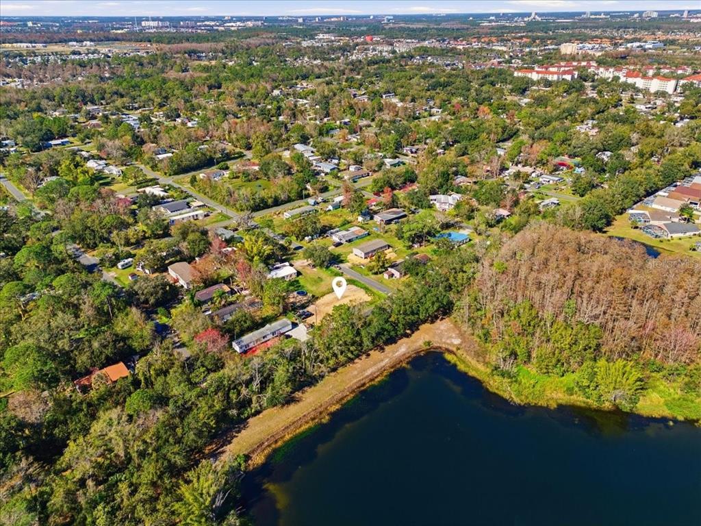 An aerial view shows a vacant lot marked with a pin near a lake — 0 HOWISON ROAD, KISSIMMEE, FL