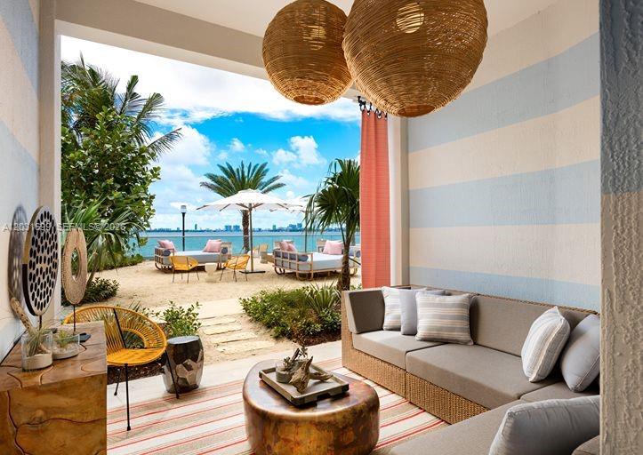 An outdoor patio features a sofa, a coffee table, and views of a beach — 2900 NE 7th Ave # 2901, Miami FL 33137, MIAMI, FL