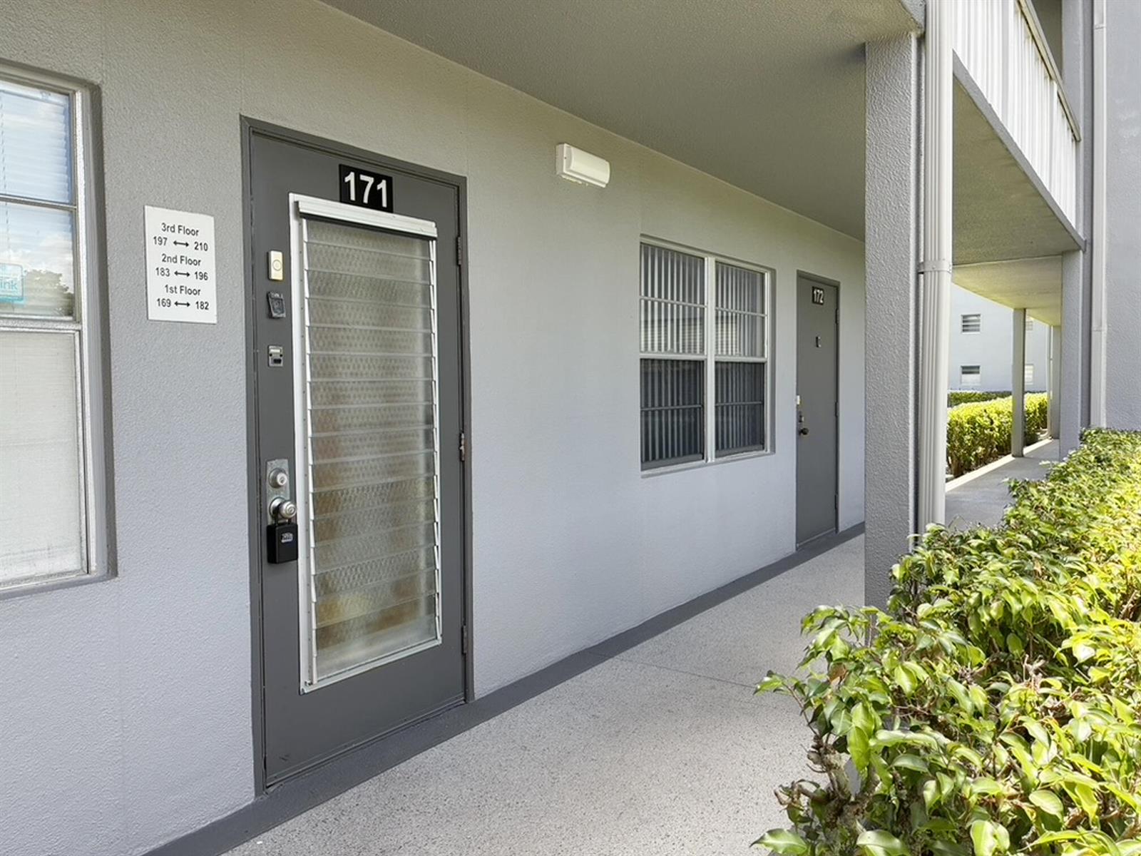 An exterior view of a building hallway showing apartment doors numbered 171 and 172 — 171 Suffolk F # 171, Boca Raton FL 33434, BOCA RATON, FL