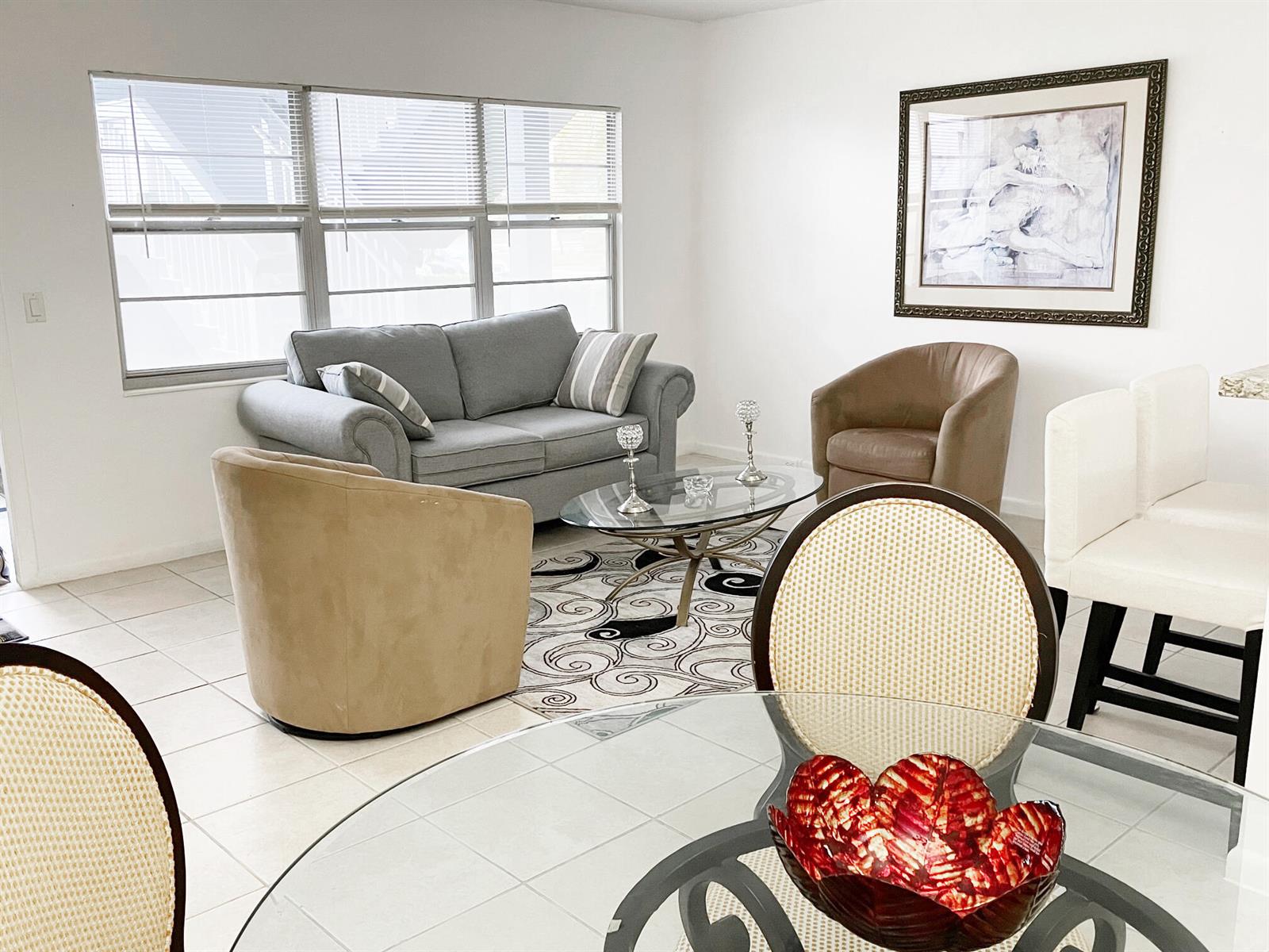 A living room with a grey sofa, two armchairs, and a glass coffee table — 171 Suffolk F # 171, Boca Raton FL 33434, BOCA RATON, FL