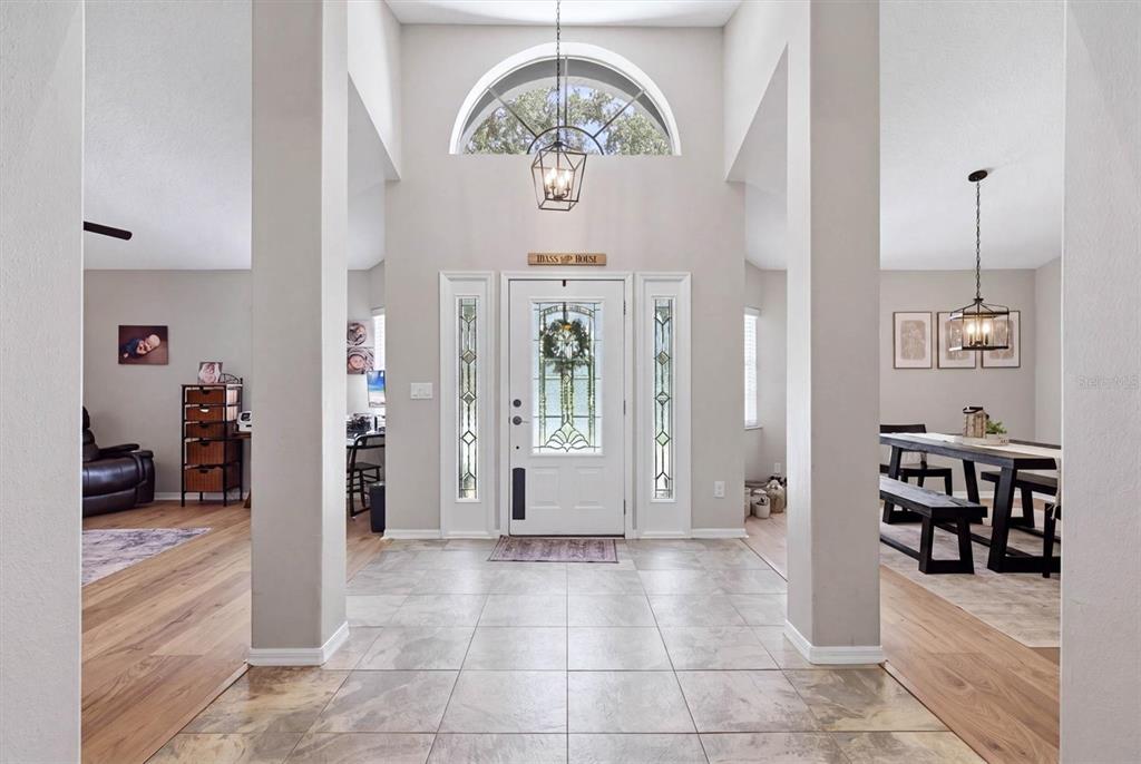 A tiled foyer features a white front door with sidelights, a transom window, and columns — 4917 SE BROWN ROAD, ARCADIA, FL