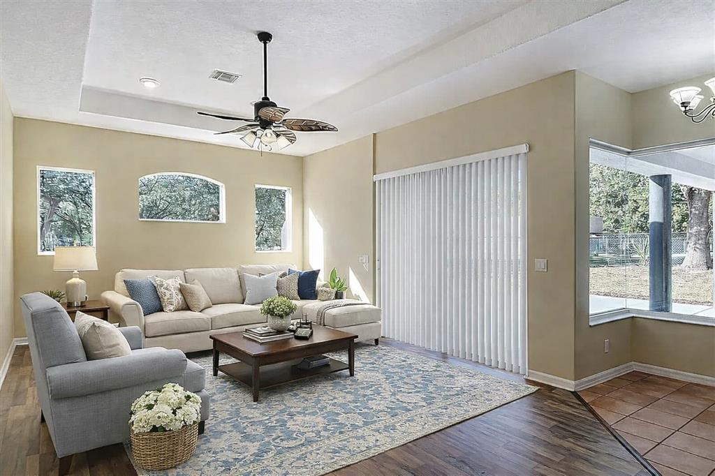 A living room features a sectional sofa, an armchair, a coffee table, and sliding doors — 949 HAWK LANDING, FRUITLAND PARK, FL