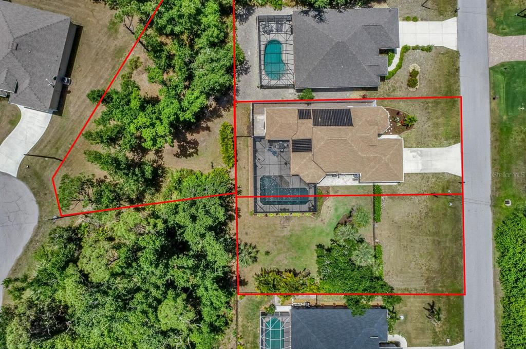 This aerial view shows a residential property with a house, pool, and large backyard — 139 CREVALLE ROAD, ROTONDA WEST, FL