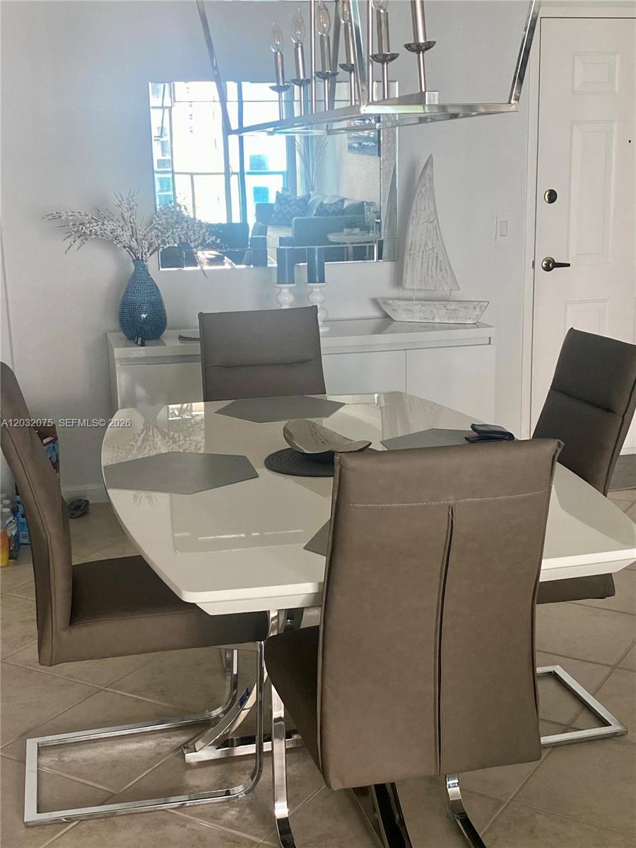 A dining room features a white table, four gray chairs, and a decorative sailboat — 2501 S Ocean Dr, Hollywood FL 33019, HOLLYWOOD, FL