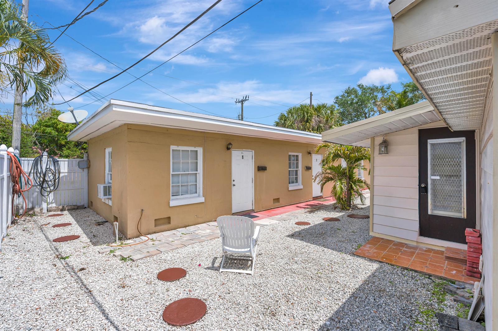 A single-story house with light-colored siding, a front porch, and a grassy yard — 505 Foresteria Drive, Lake Park FL 33403, LAKE PARK, FL