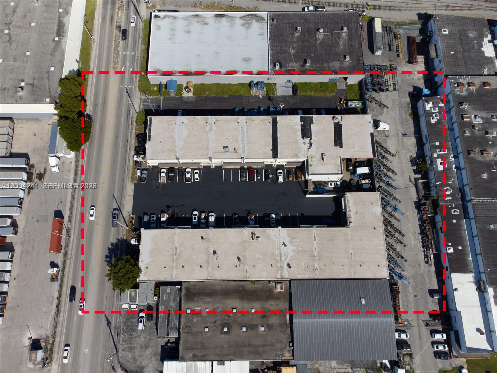 This aerial view shows a commercial warehouse complex with parking lots and surrounding industrial buildings — 7335 NW 32nd Ave # 7345, Miami FL 33147, MIAMI, FL