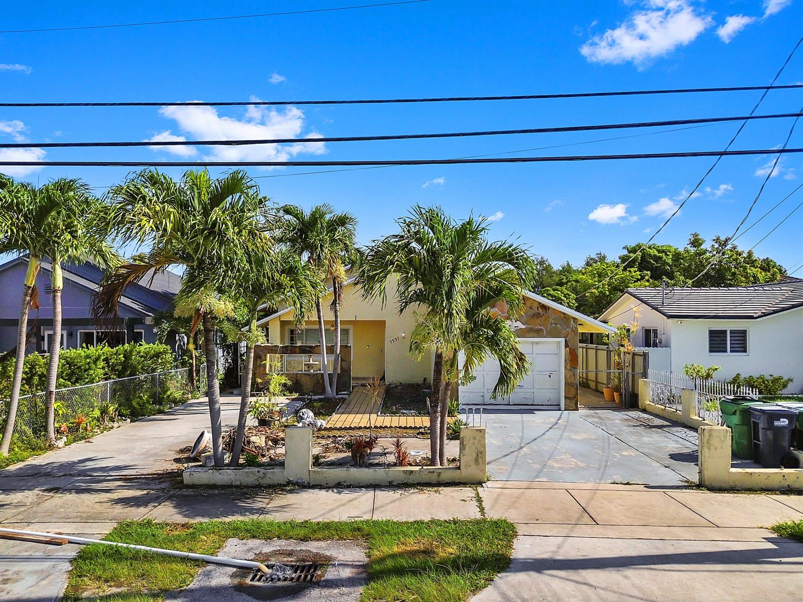 A single-story house with a stone-accented garage and palm trees in the front yard — 7337 SW 21st Street, Miami FL 33155, MIAMI, FL