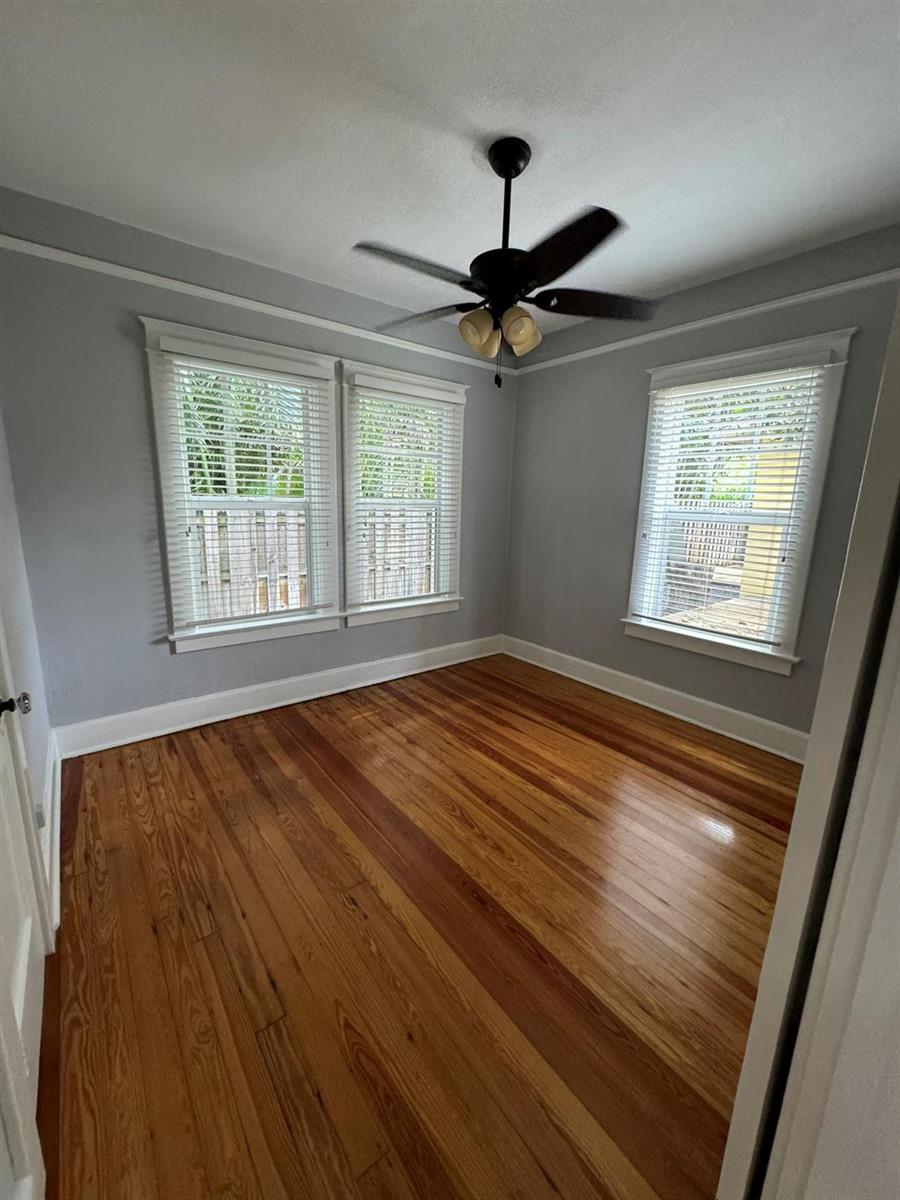 An empty room with gray walls, hardwood floors, a ceiling fan, and three windows — 226 NE 7th, Delray Beach FL 33483, DELRAY BEACH, FL