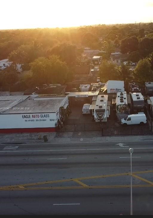 An aerial view shows an Eagle Auto Glass business with several parked RVs and vehicles — 10400 SW 27th St, Miami FL 33165, MIAMI, FL