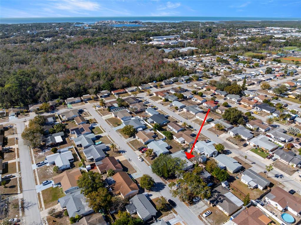 An aerial view shows a residential neighborhood with a red arrow pointing to a house — 6333 ABERDEEN AVENUE, NEW PORT RICHEY, FL