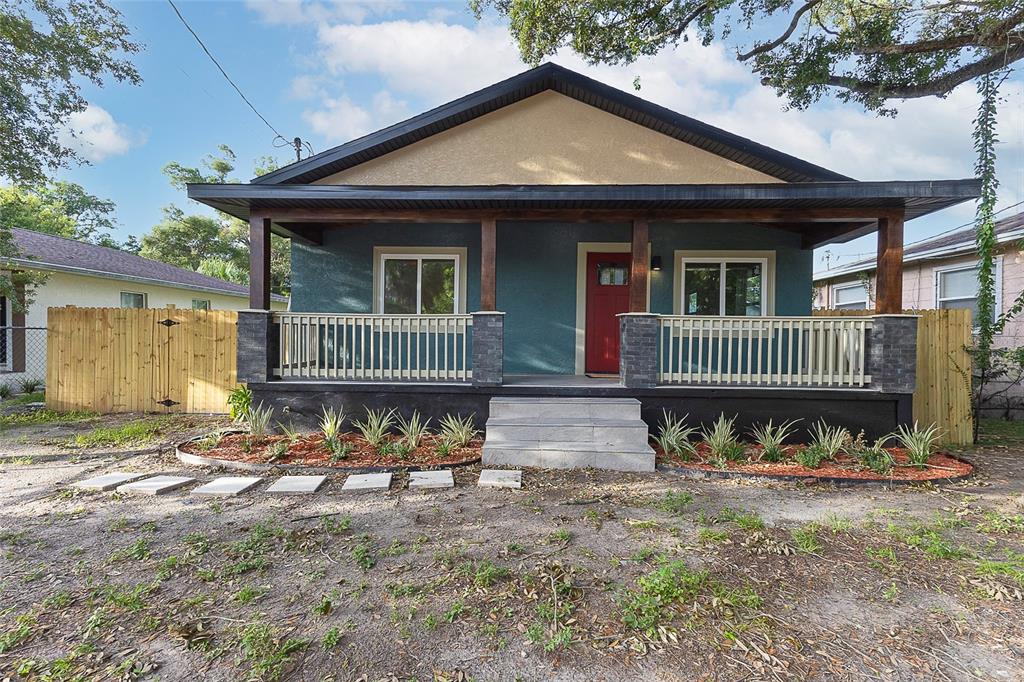 A blue house with a front porch, stone pillars, and a red front door — 3203 E EMMA STREET, TAMPA, FL