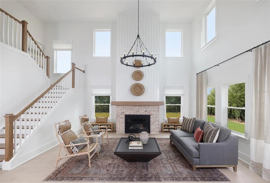 A kitchen with white cabinets, a quartz island, stainless steel appliances, and a subway tile backsplash — 2672 VERONA LANE, ODESSA, FL