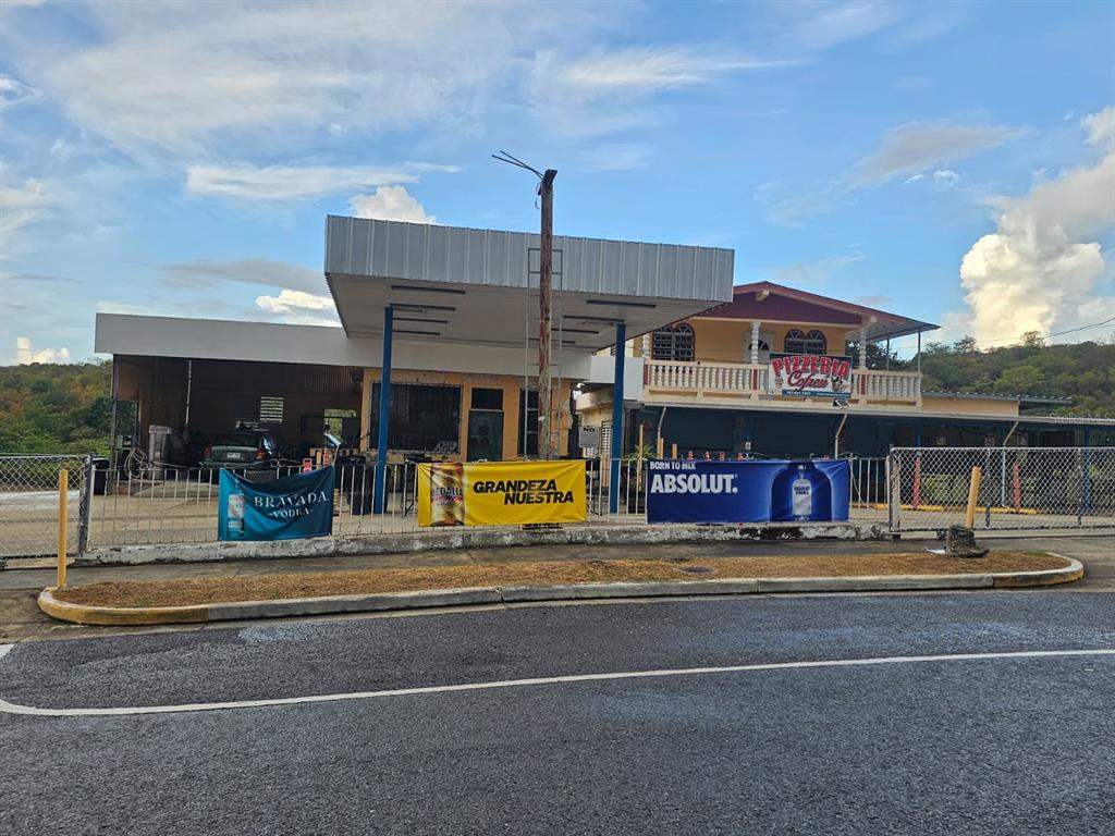 A roadside building with a covered service area and an adjacent two-story pizzeria — Carr. 307, Km. 5.2 BARRIO PEDERNALES, CABO ROJO, PR