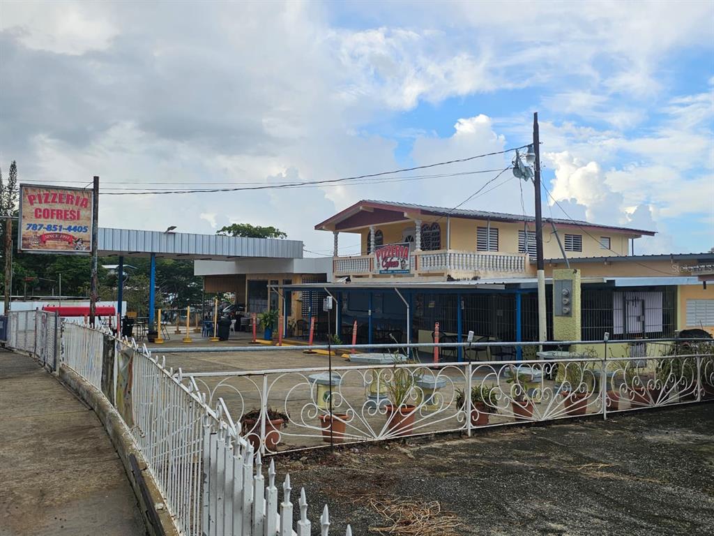 A two-story building with a pizzeria sign, a parking area, and a white metal fence — Carr. 307, Km. 5.2 BARRIO PEDERNALES, CABO ROJO, PR