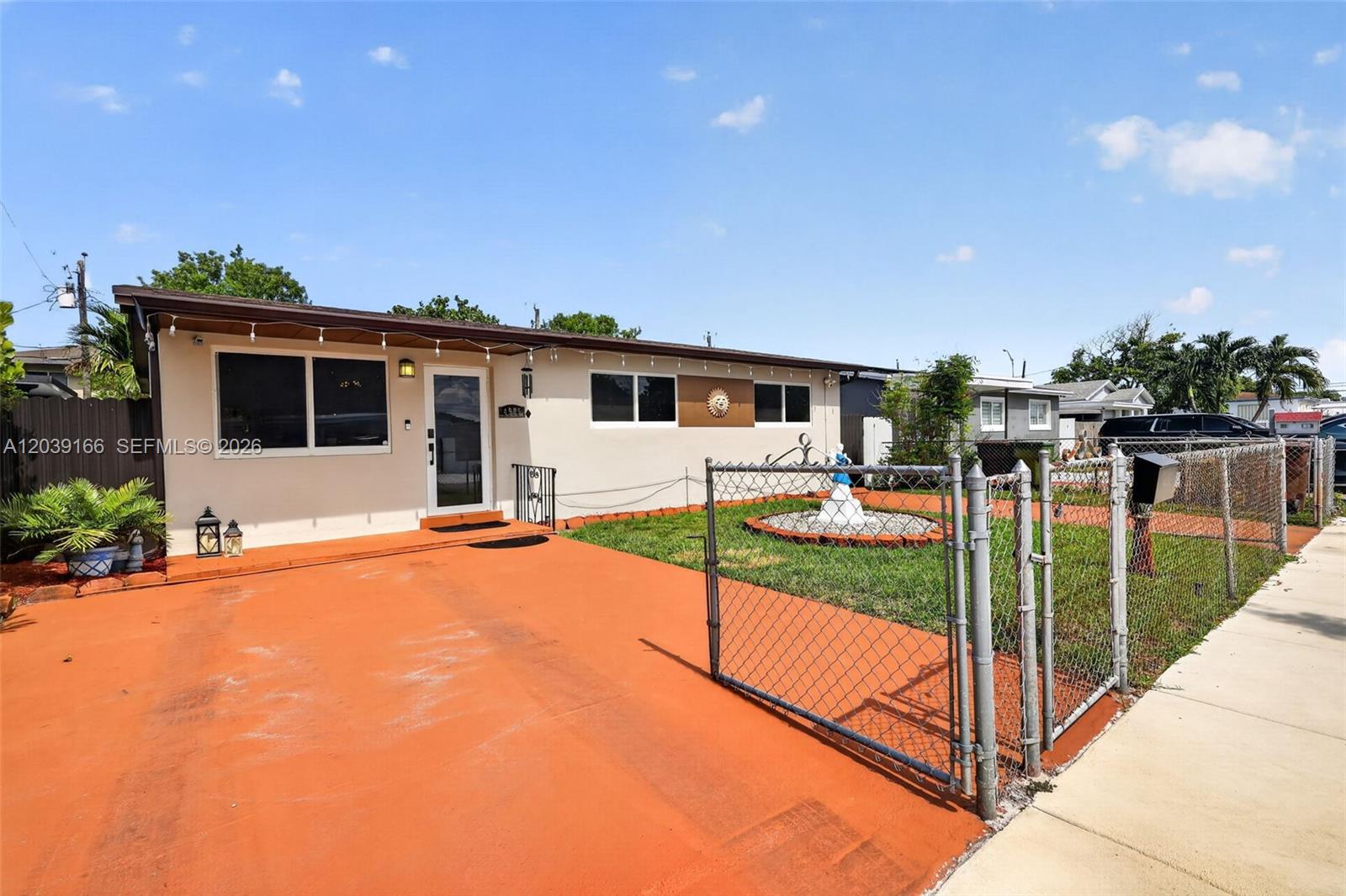 A single-story house features a tan exterior, a red driveway, and a chain-link fence — 4585 E 9th Ln, Hialeah FL 33013, HIALEAH, FL