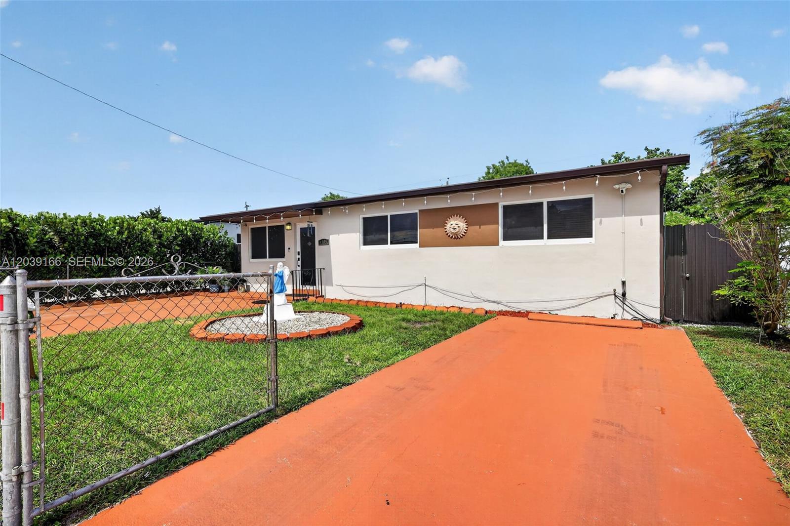 A single-story house features a painted driveway, a fenced front yard, and a small statue — 4585 E 9th Ln, Hialeah FL 33013, HIALEAH, FL