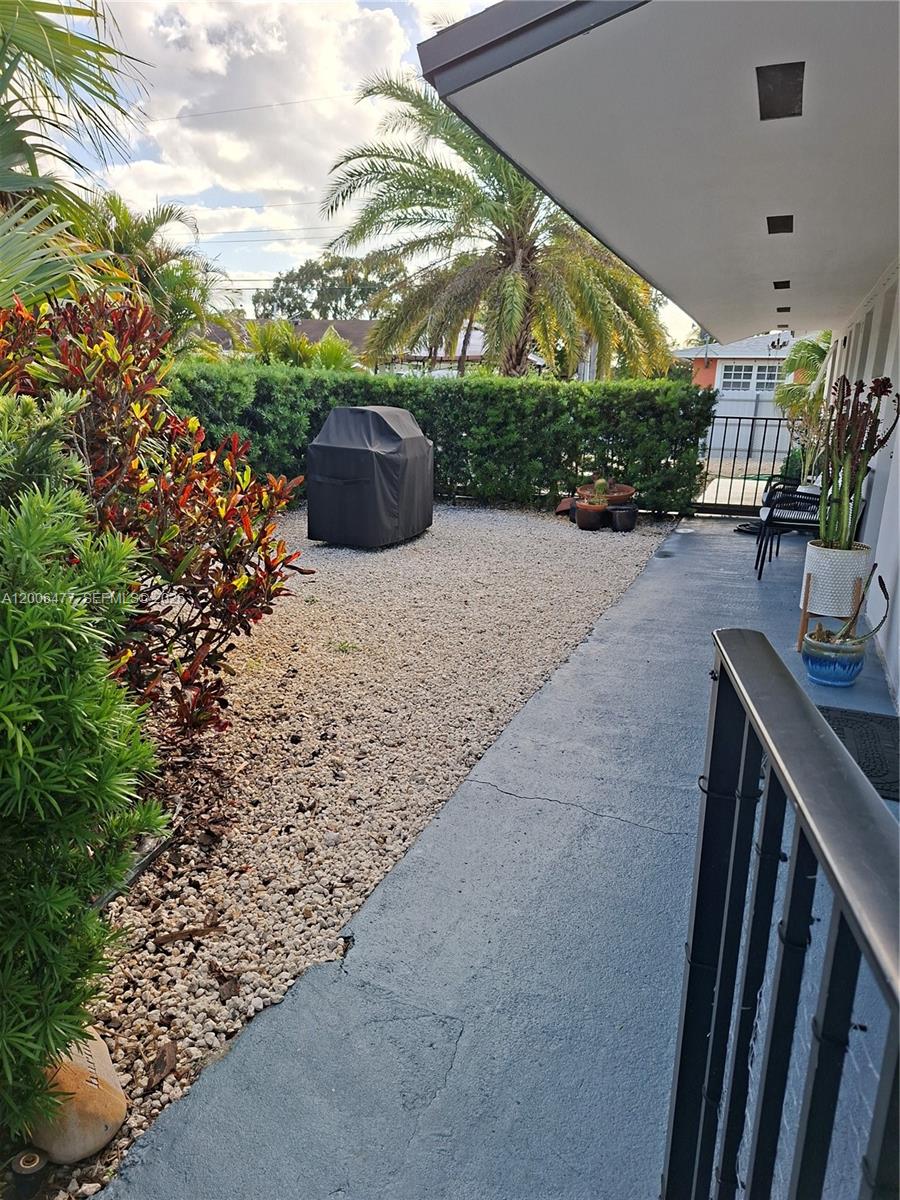 A covered patio overlooks a gravel yard with a grill and a hedge — 1814 SW 97th Terrace # A, Miramar FL 33025, MIRAMAR, FL