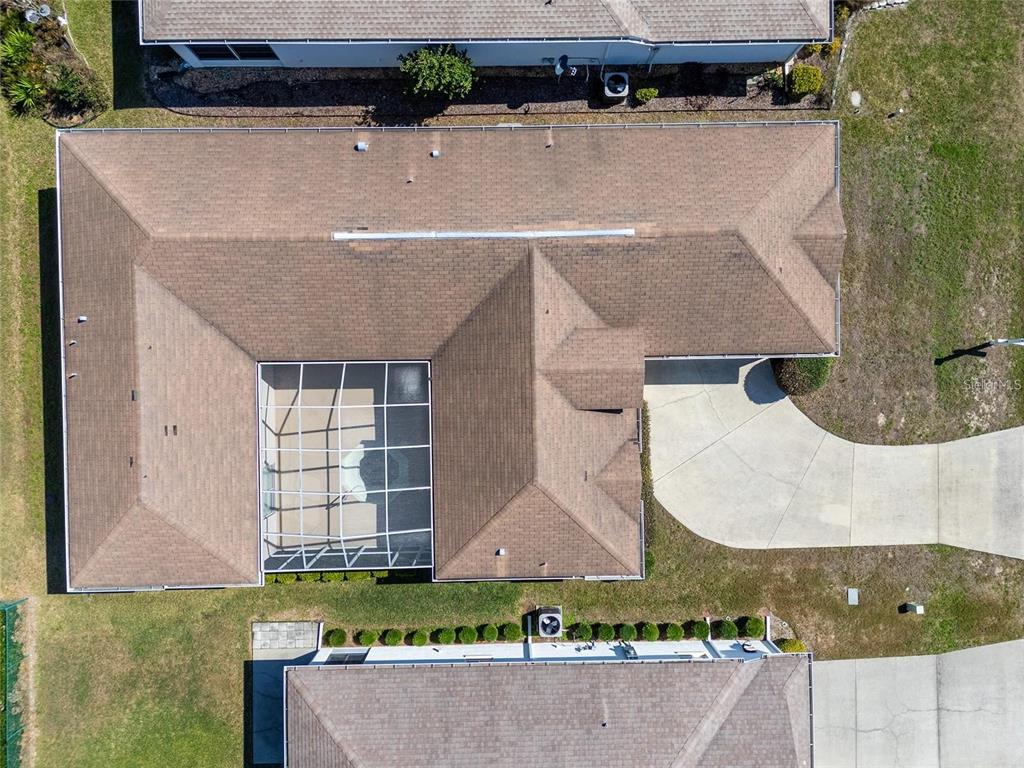 An aerial view shows a house with a brown shingled roof and a screened-in pool — 5891 NW 26TH STREET, OCALA, FL