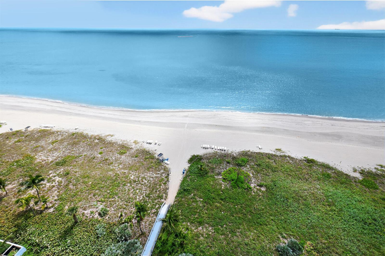 An aerial view shows a sandy beach with a wooden walkway leading to the ocean — 1500 S Ocean Boulevard, Boca Raton FL 33432, BOCA RATON, FL