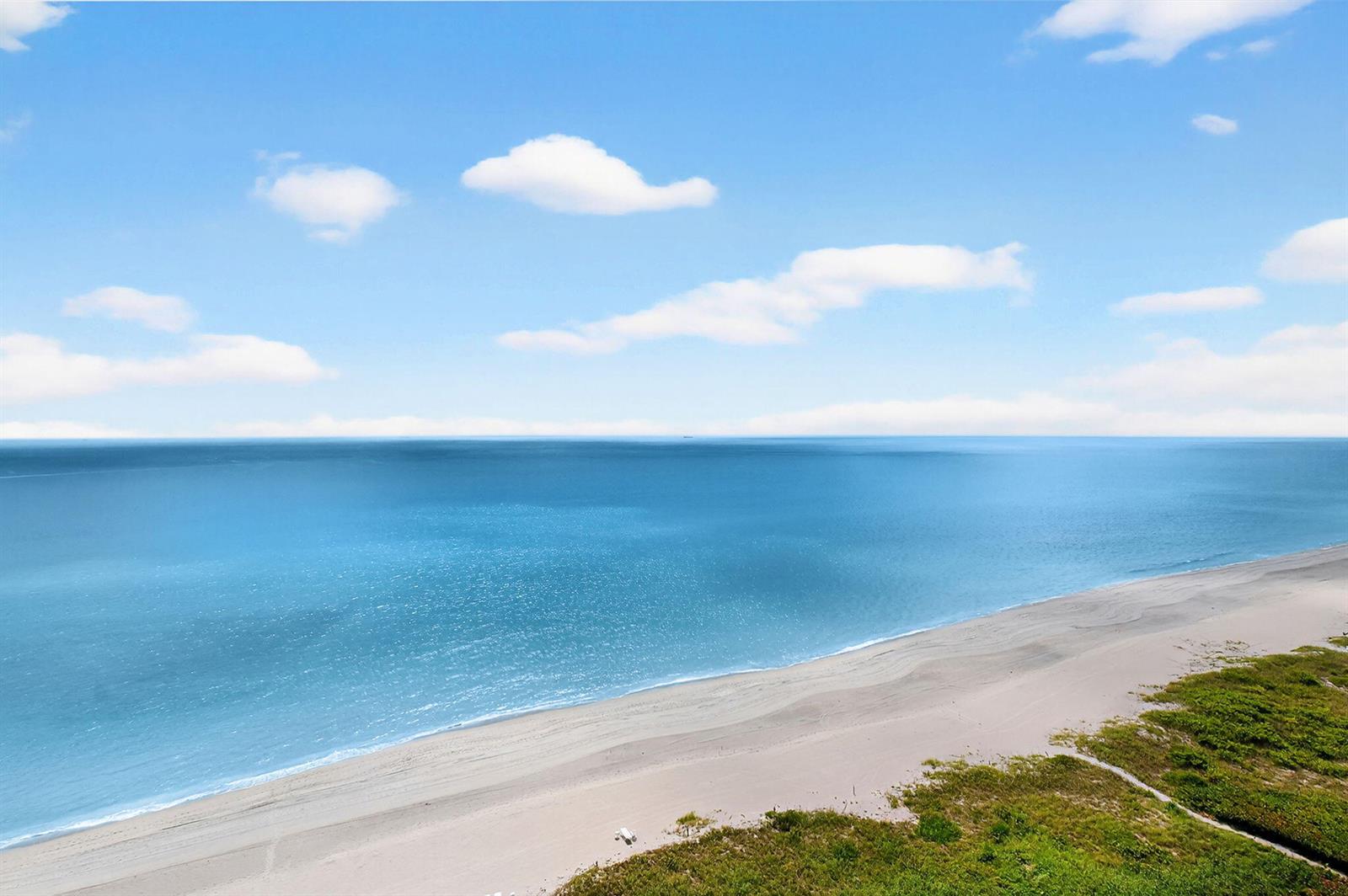 An aerial view of a sandy beach meeting the blue ocean under a cloudy sky — 1500 S Ocean Boulevard, Boca Raton FL 33432, BOCA RATON, FL
