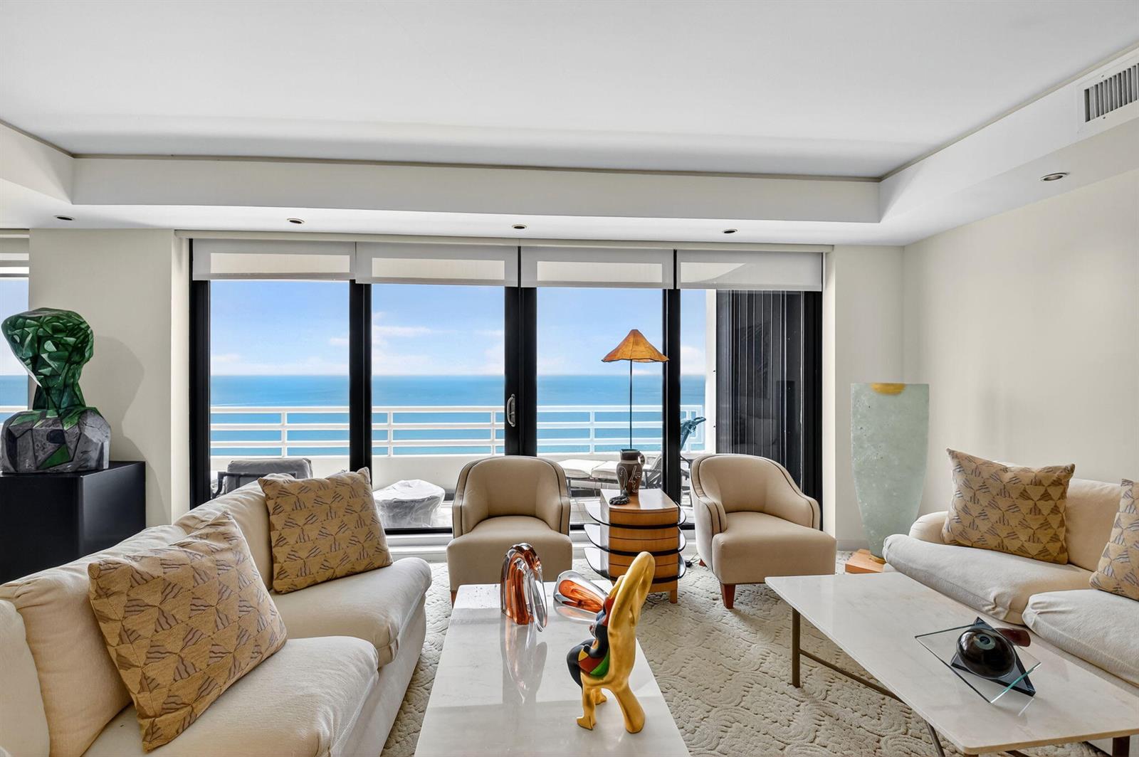 A living room with two sofas, two armchairs, and a balcony overlooking the ocean — 1500 S Ocean Boulevard, Boca Raton FL 33432, BOCA RATON, FL