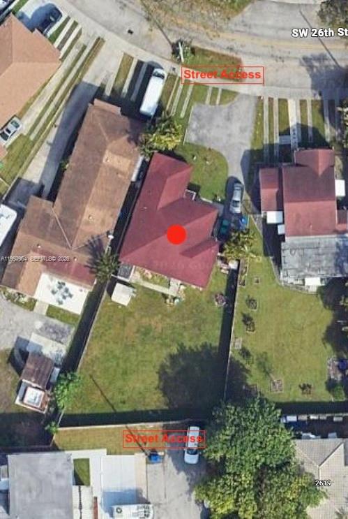 This aerial view shows a residential property with a red roof and a large backyard — 3180 SW 26th St, Miami FL 33133, MIAMI, FL