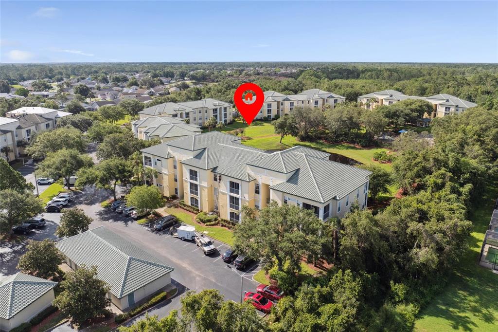 An aerial view shows a multi-story apartment complex with a red location pin — 8816 DUNES COURT UNIT 303, KISSIMMEE, FL