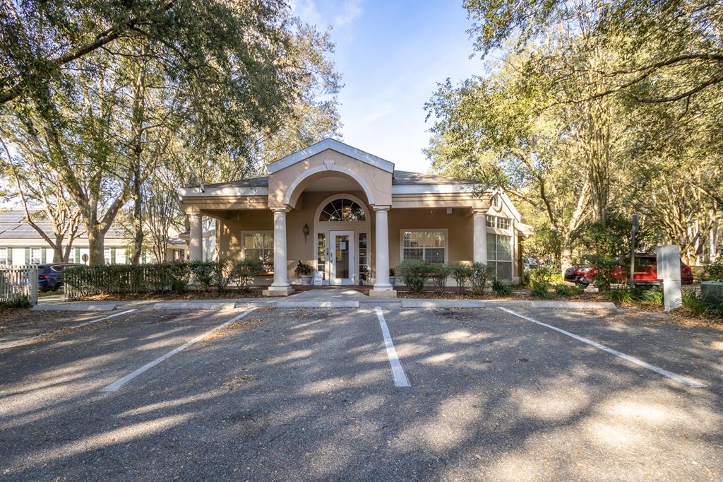 A single-story building with a columned entrance stands behind a paved parking lot — 5213 & 5217 & 5231 SW 91ST DRIVE, GAINESVILLE, FL