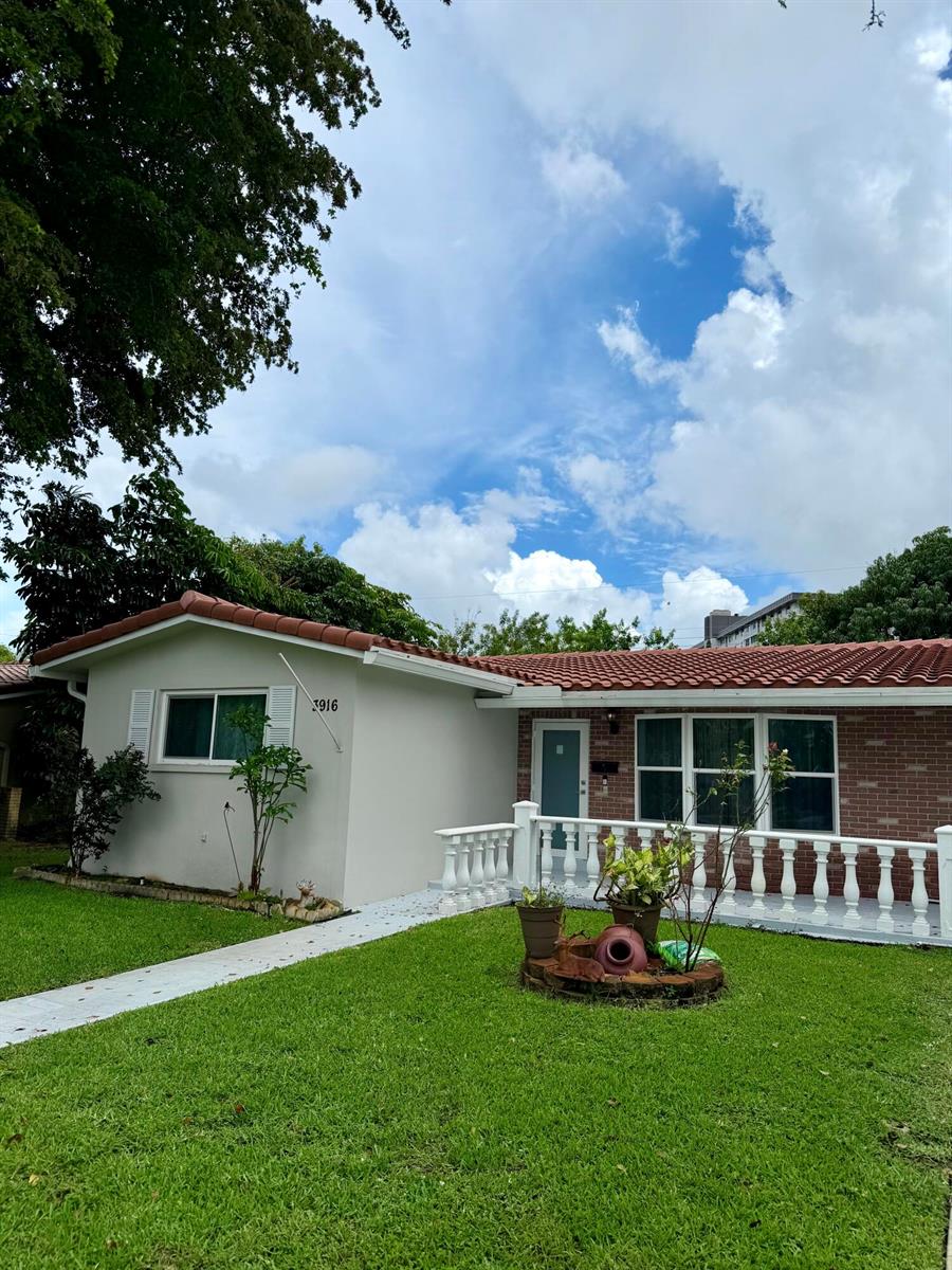 A single-story house with a white stucco and brick facade, red tile roof, and porch — 3916 Adams Street, Hollywood FL 33021, HOLLYWOOD, FL