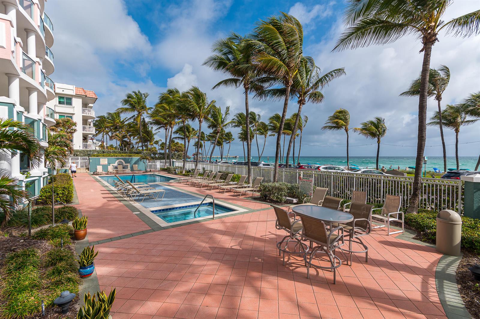 An outdoor pool and hot tub area with patio furniture overlooking the ocean — 2051 SE 3rd Street # 101, Deerfield Beach FL 33441, DEERFIELD BEACH, FL