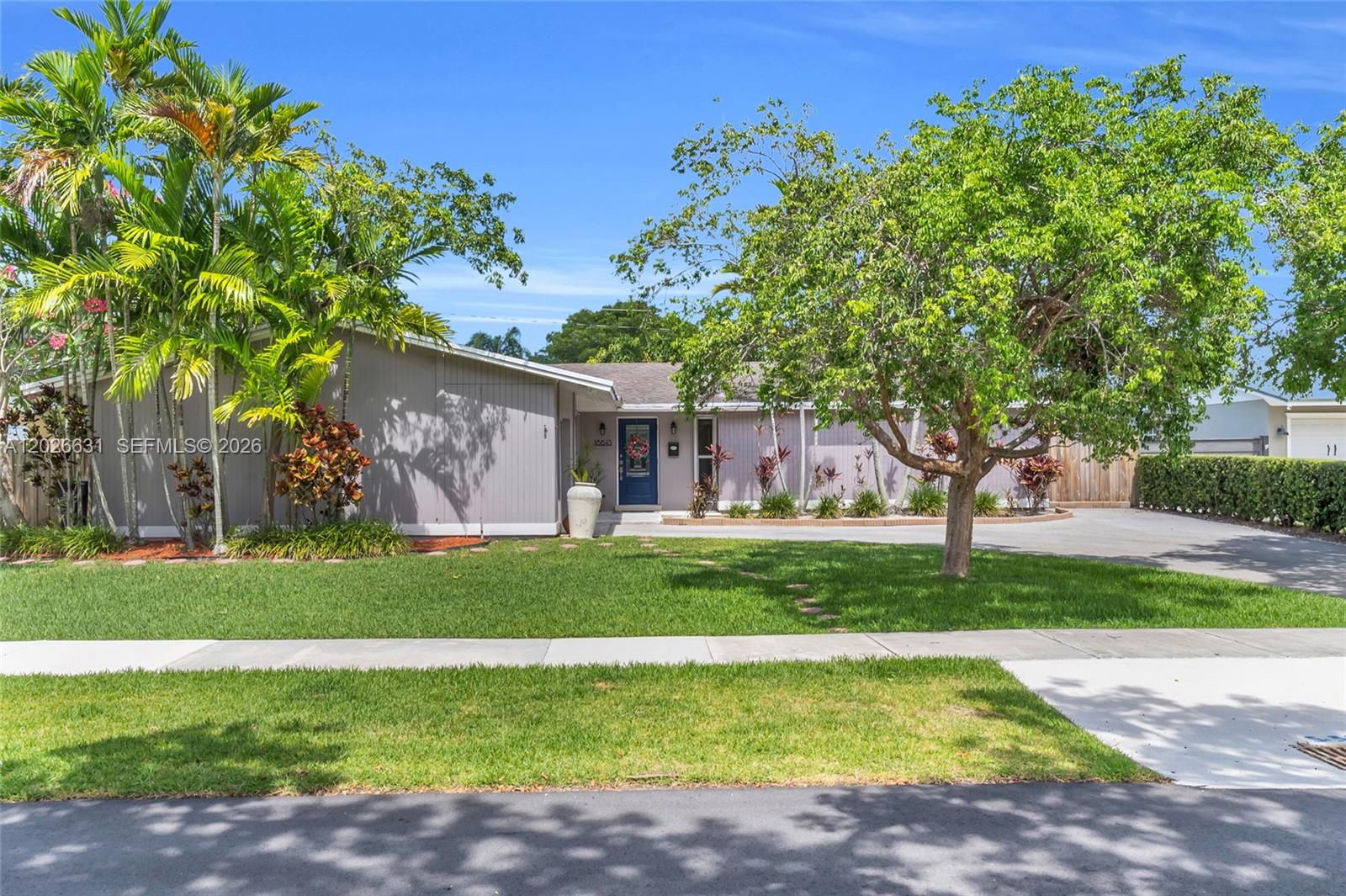 A single-story house with a blue front door, palm trees, and a large front lawn — 18645 SW 90th Ave, Cutler Bay FL 33157, CUTLER BAY, FL