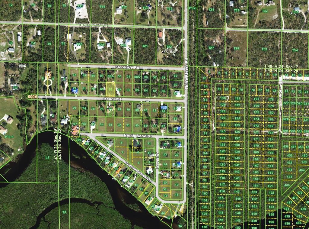 This is an aerial map showing residential lots, roads, and a nearby waterway — 31062 PEACE STREET, PUNTA GORDA, FL