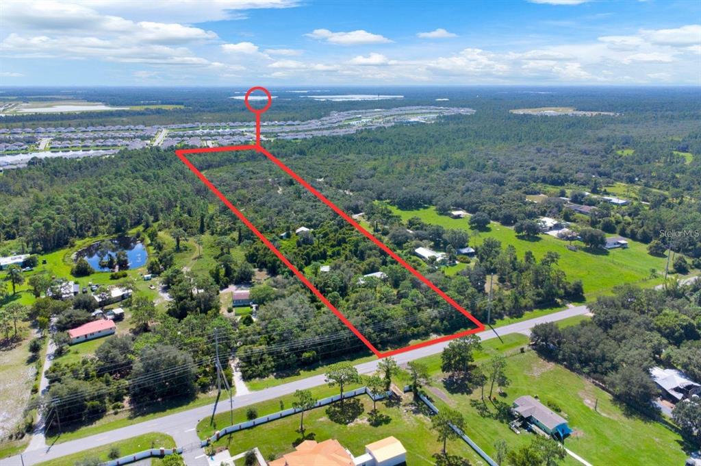 An aerial view shows a rectangular plot of land outlined in red near a road — 2795 ABSHER ROAD, ST CLOUD, FL