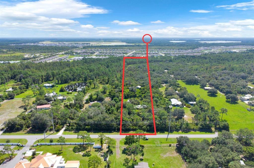 An aerial view shows a rectangular plot of land outlined in red near a road — 2795 ABSHER ROAD, ST CLOUD, FL
