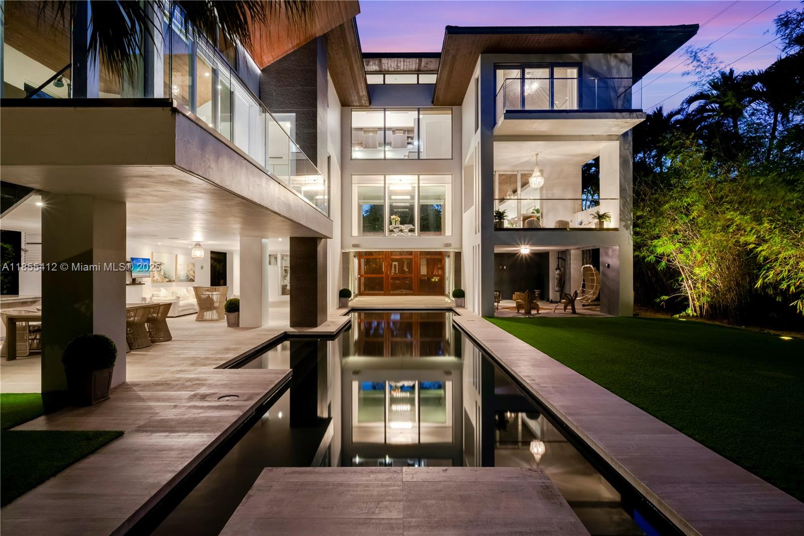 A modern multi-story home features a rectangular swimming pool, covered patio, and landscaped backyard — 545 SABAL PALM, Key Biscayne FL 33149, KEY BISCAYNE, FL