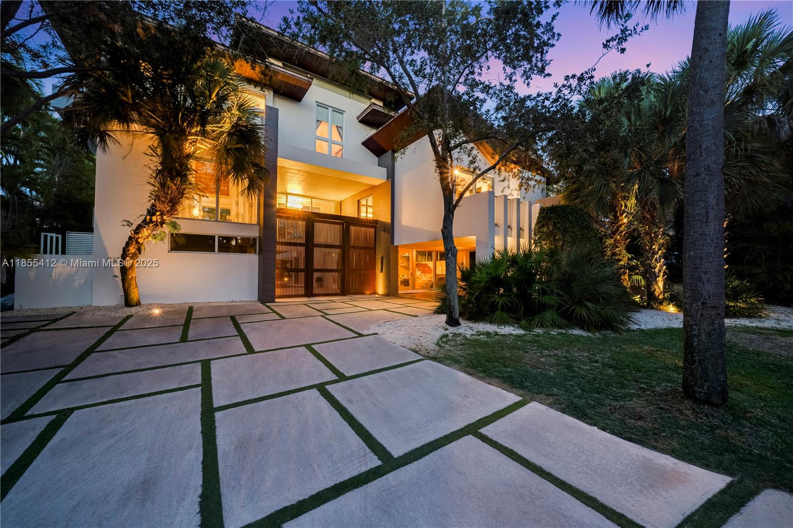 A modern two-story house with a paved driveway and palm trees at dusk — 545 SABAL PALM, Key Biscayne FL 33149, KEY BISCAYNE, FL